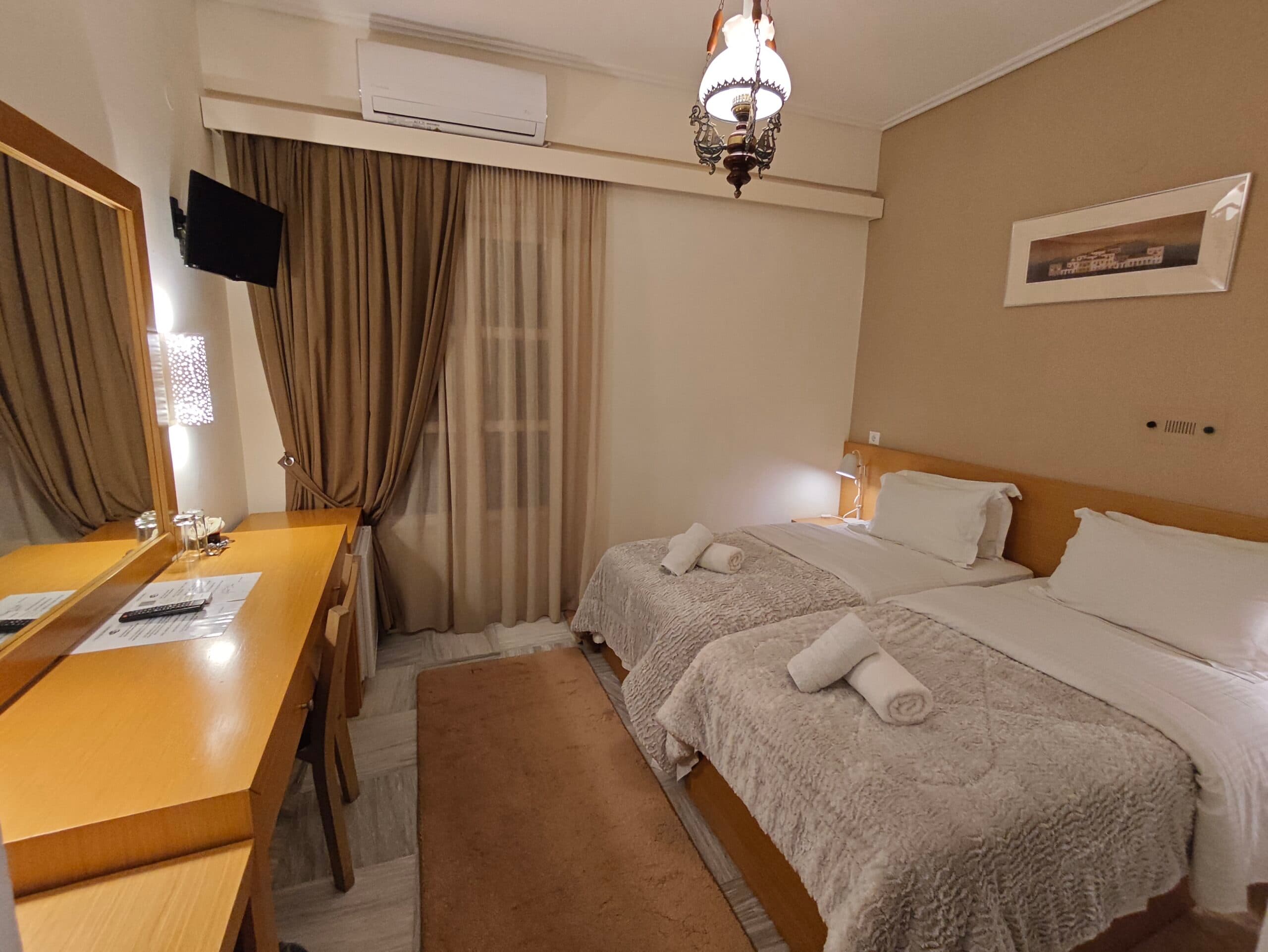 A second-floor guest room with balcony doors