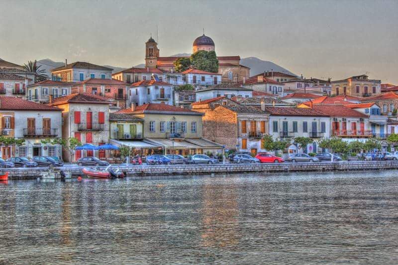 The harbour of Galaxidi at dusk, stone houses reflected in the water