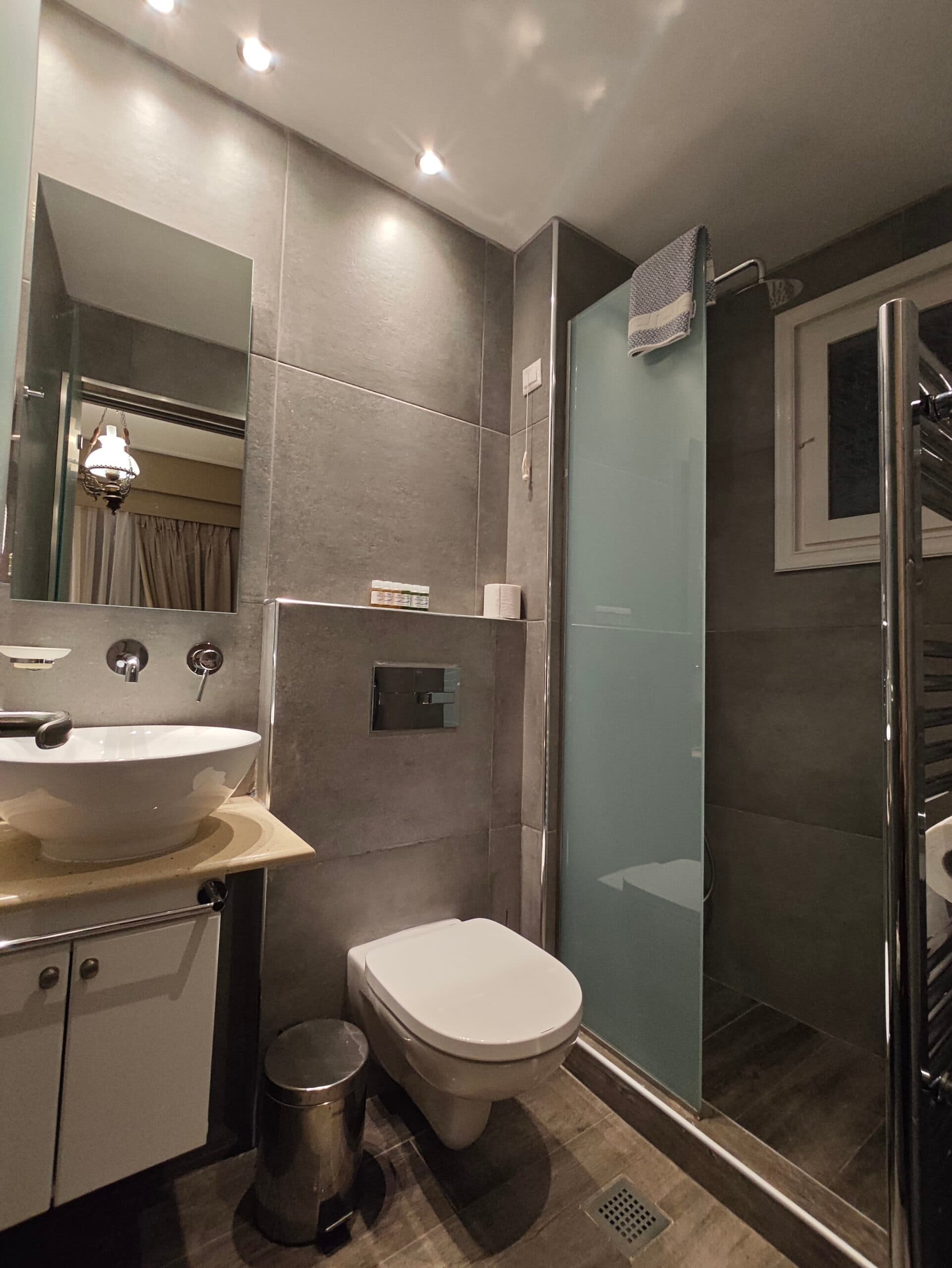 A triple room with three beds made up with white linen